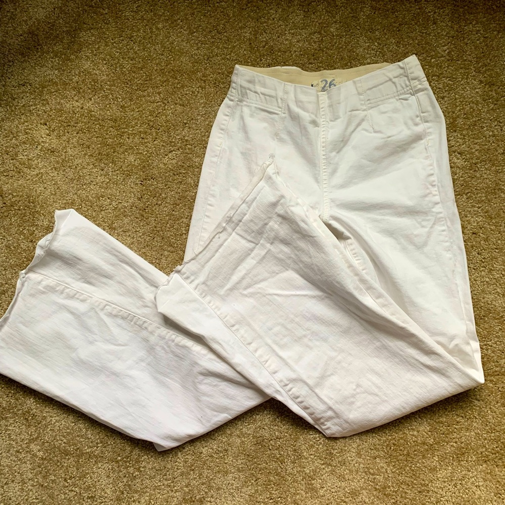 white FREE PEOPLE flared jeans with frayed bottoms and an elastic waistband